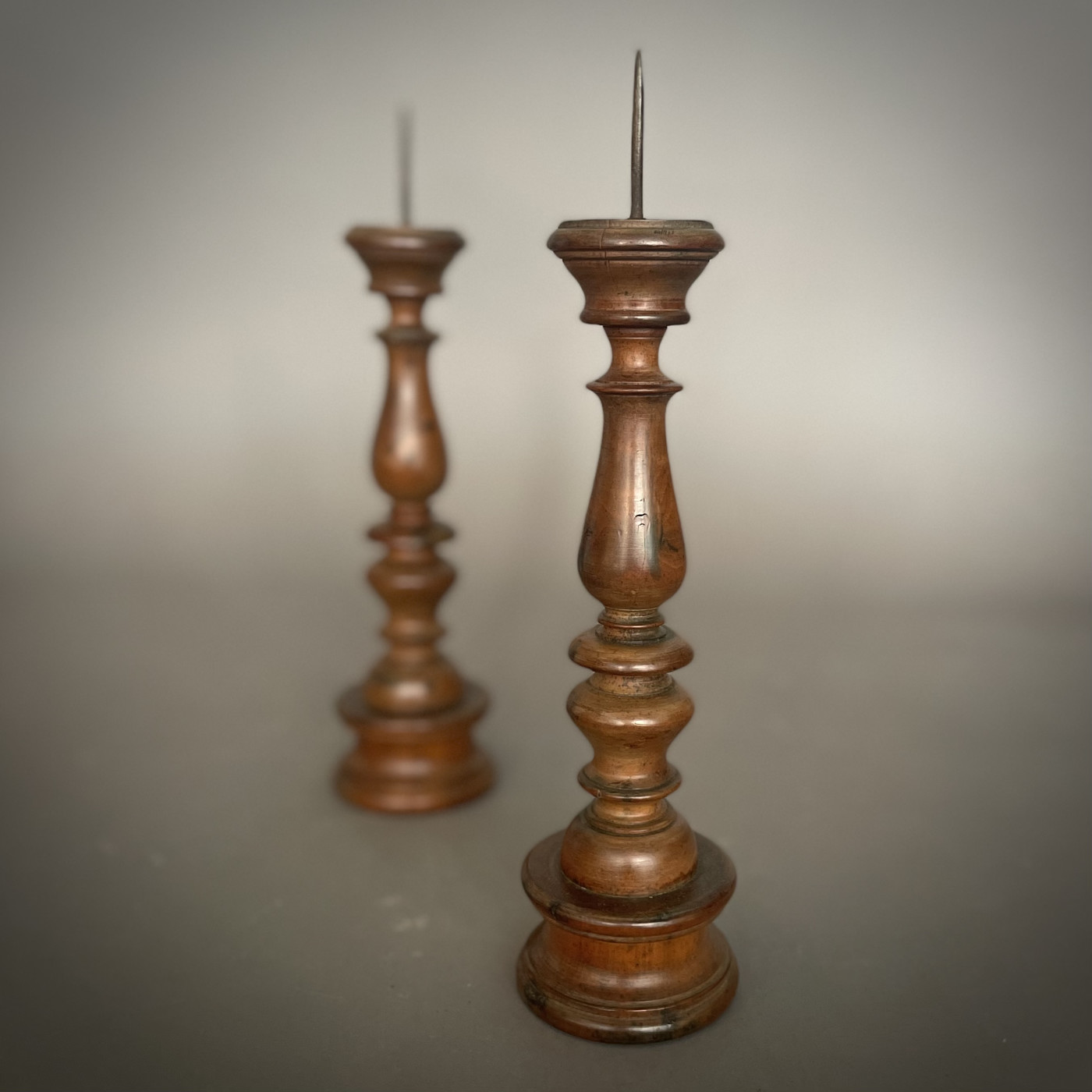 Pair of Italian walnut candlesticks