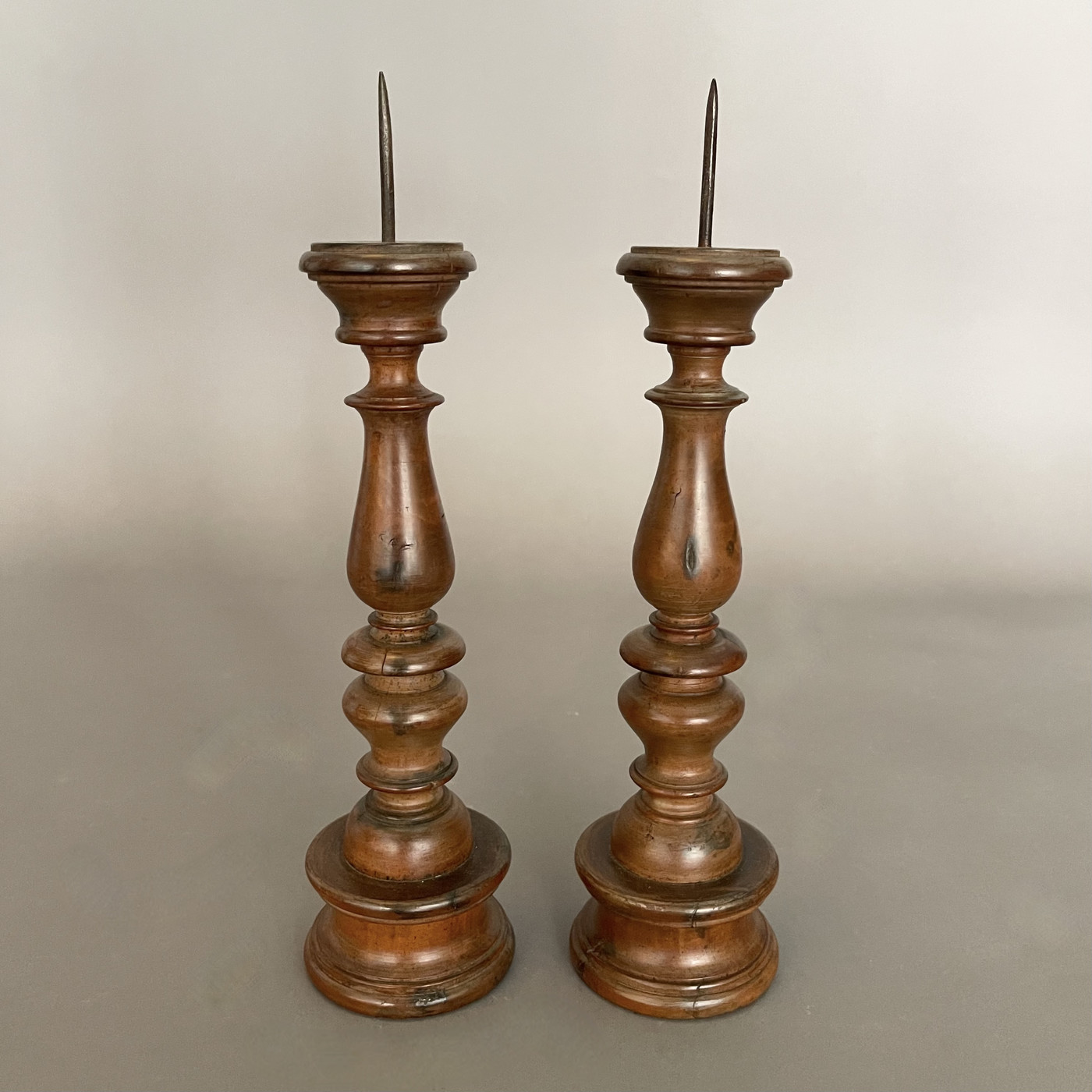 Pair of Italian walnut candlesticks